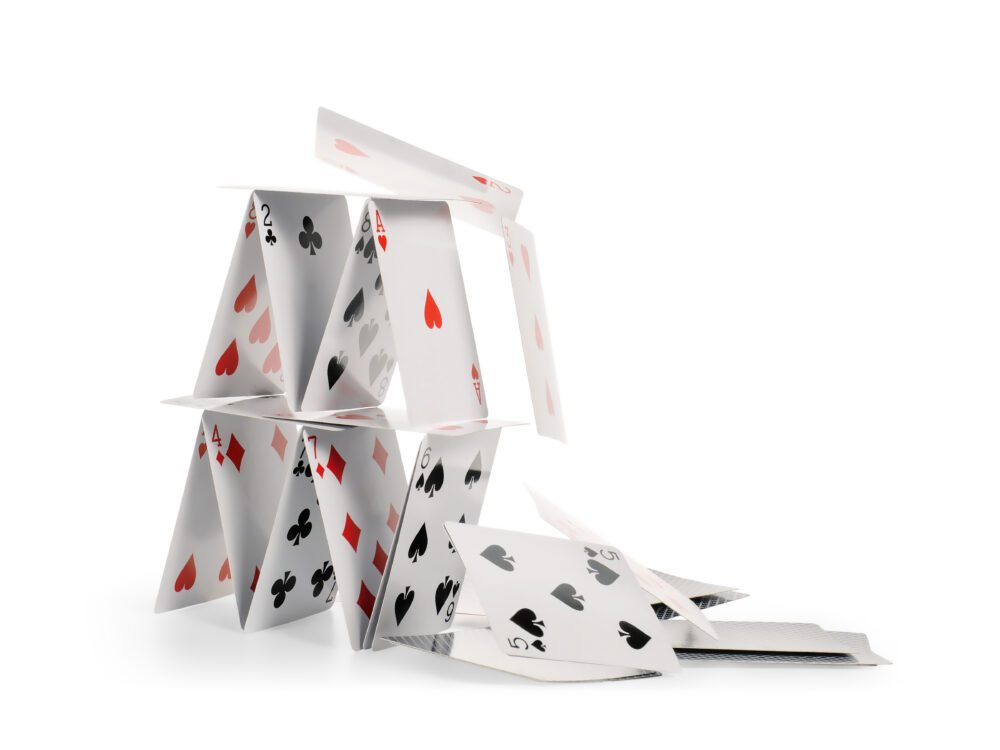 Falling house of cards isolated with clipping path